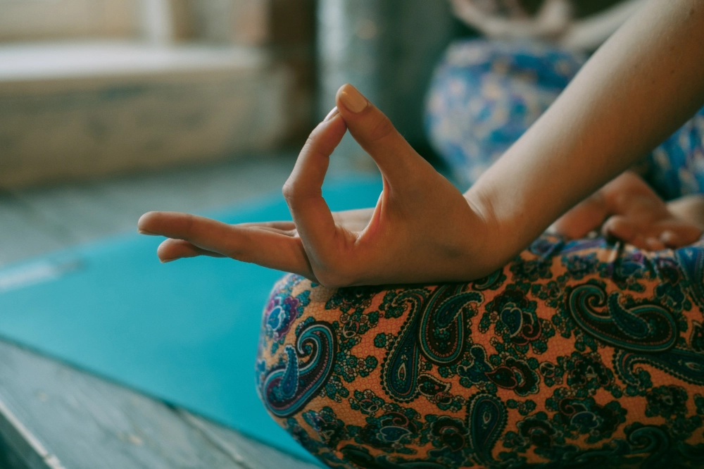 web_kilyOM_woman-meditating-in-the-lotus-position-closeup-2024-09-17-18-28-46-utc